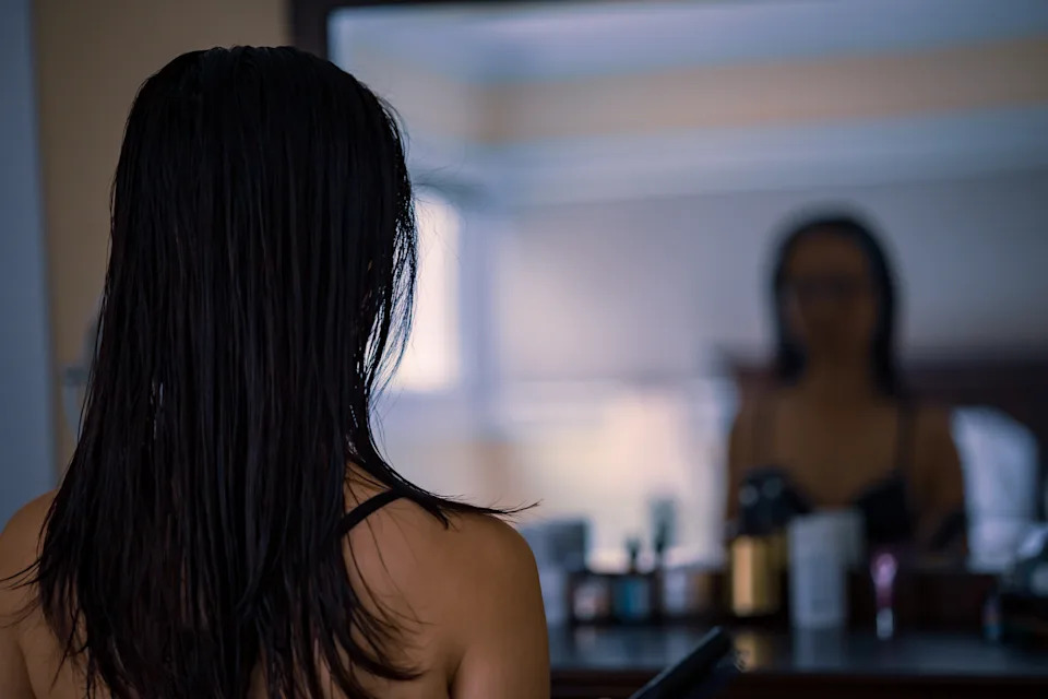 portrait of middle-aged woman looking at herself in the mirror.
