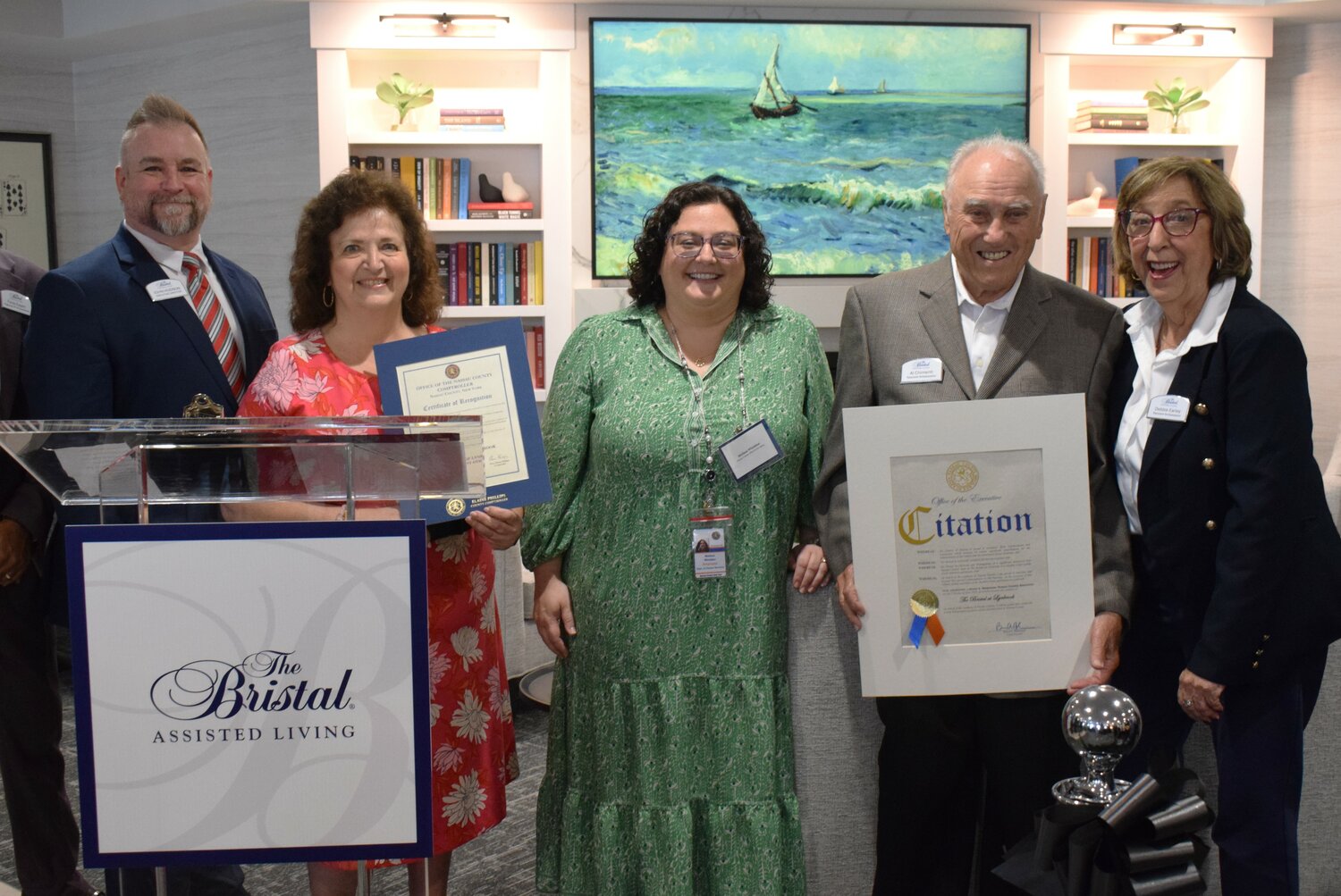 Executive Director John Hudson, left, Nassau County Official Representatives Irene Villacci and Melissa Whiddon, Resident Ambassadors Al Chimenti and Debbie Earley at the ribbon cutting.