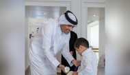 Prime Minister and Minister of Foreign Affairs H E Sheikh Mohammed bin Abdulrahman bin Jassim Al-Thani with a child. Picture shared by the Education Minister in a social media post.
