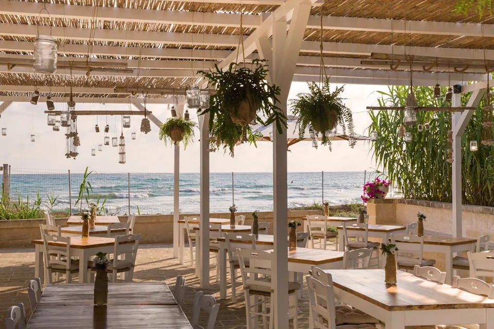Outdoor dining at Giuàmmare Restaurant with sea views at Canne Bianche Lifestyle Hotel in Puglia