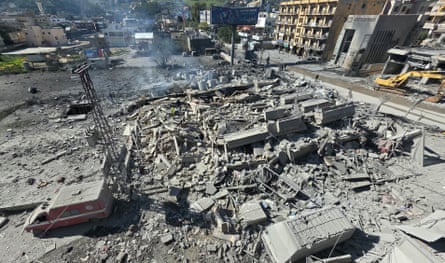 Building rubble and burned-out vehicles in the aftermath of an airstrike