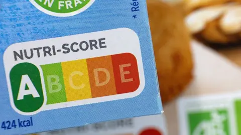 AFP via Getty Images The Nutri-Score colour-coded ranking on some food packaging. It runs from A to E and from green to red.