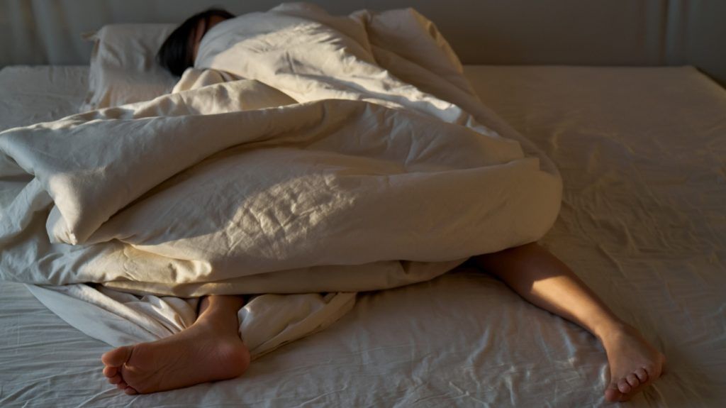 A person sleeping in bed.