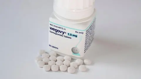 Getty Images A pot of 1.5mg Wegovy medication with 30 tablets. The small white tablets can be seen resting next to the pot.