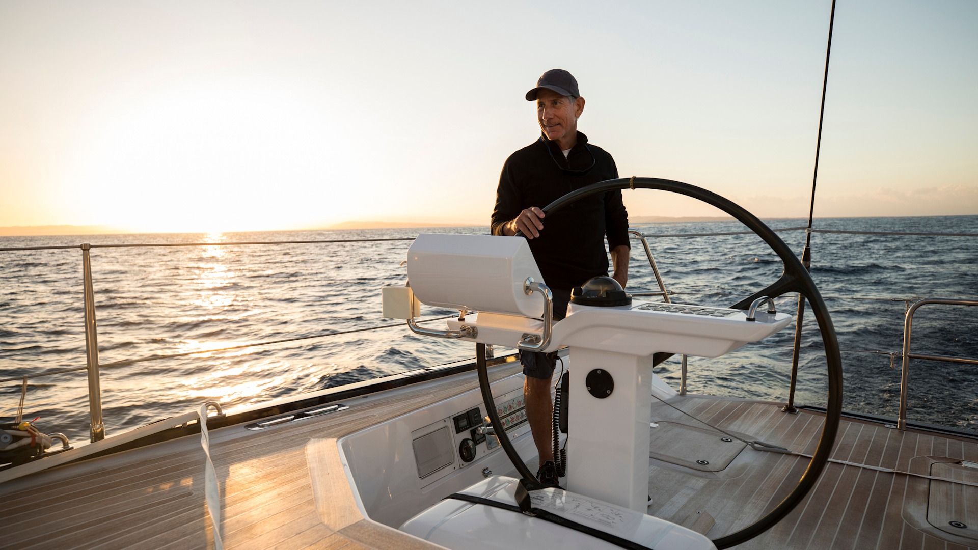 Discover a man sailing a beautiful yacht on the open ocean - stock photo wealthy, boat, sailing