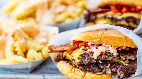 Getty Images A stock image of a cheese burger and french fries.