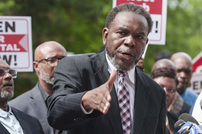Pastor Ira Acree, who leads Greater St. John Bible Church, speaks during a rally in late May with dozens of religious leaders, health care workers and community members outside West Suburban Medical Center to demand its reopening.