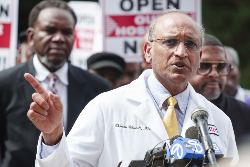 Dr. Vishnu Chundi, an infectious disease doctor, speaks during a rally with dozens of religious leaders, health care workers and community members outside West Suburban Medical Center in Austin to demand the reopening of the hospital, Tuesday, May 26, 2026.