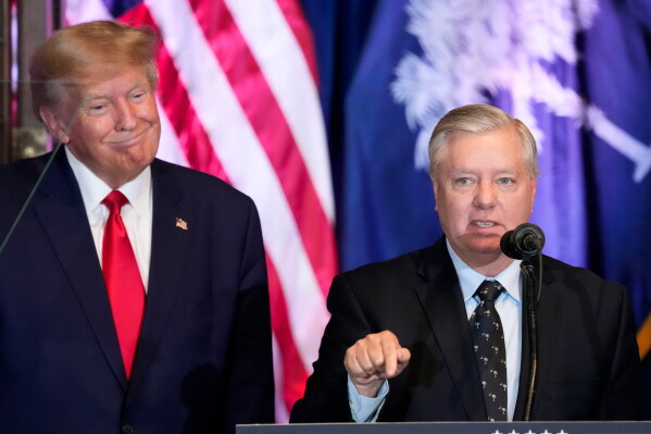 Former President Donald Trump listens as Sen. Lindsey Graham, R-S.C., speaks at a campaign event at the South Carolina Statehouse, Jan. 28, 2023, in Columbia, S.C. (AP Photo/Alex Brandon, File)