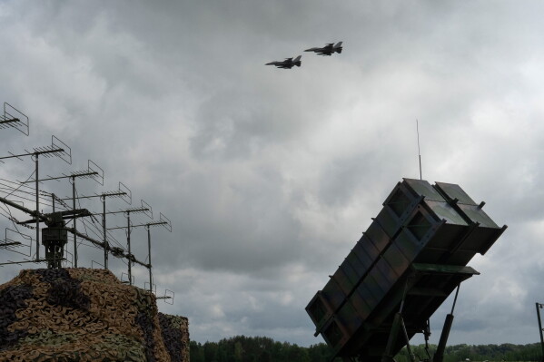 Ukrainian Air Force's F-16 fighter jets fly over a Patriot Air and Missile Defense System in an undisclosed location in Ukraine, on Aug. 4, 2024. (AP Photo/Efrem Lukatsky, File)