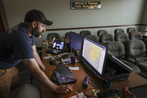 man reviews maps on computer screen