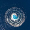 A boat is driving in a circle and produces a big whirlpool