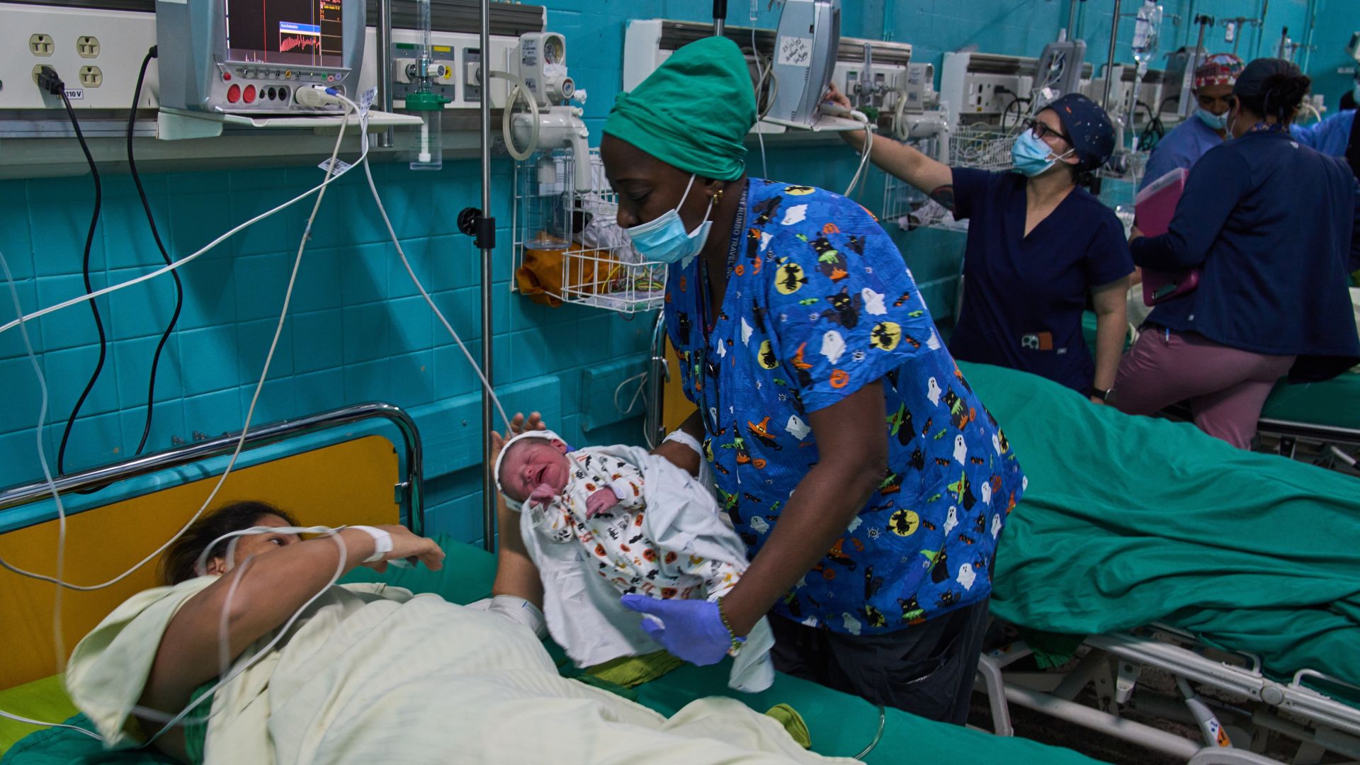 A doctor hands a newborn baby to its mother at the Ramón González Coro Maternity Hospital in Havana, Cuba, Friday, Feb. 20, 2026. (AP Photo/Ramon Espinosa)