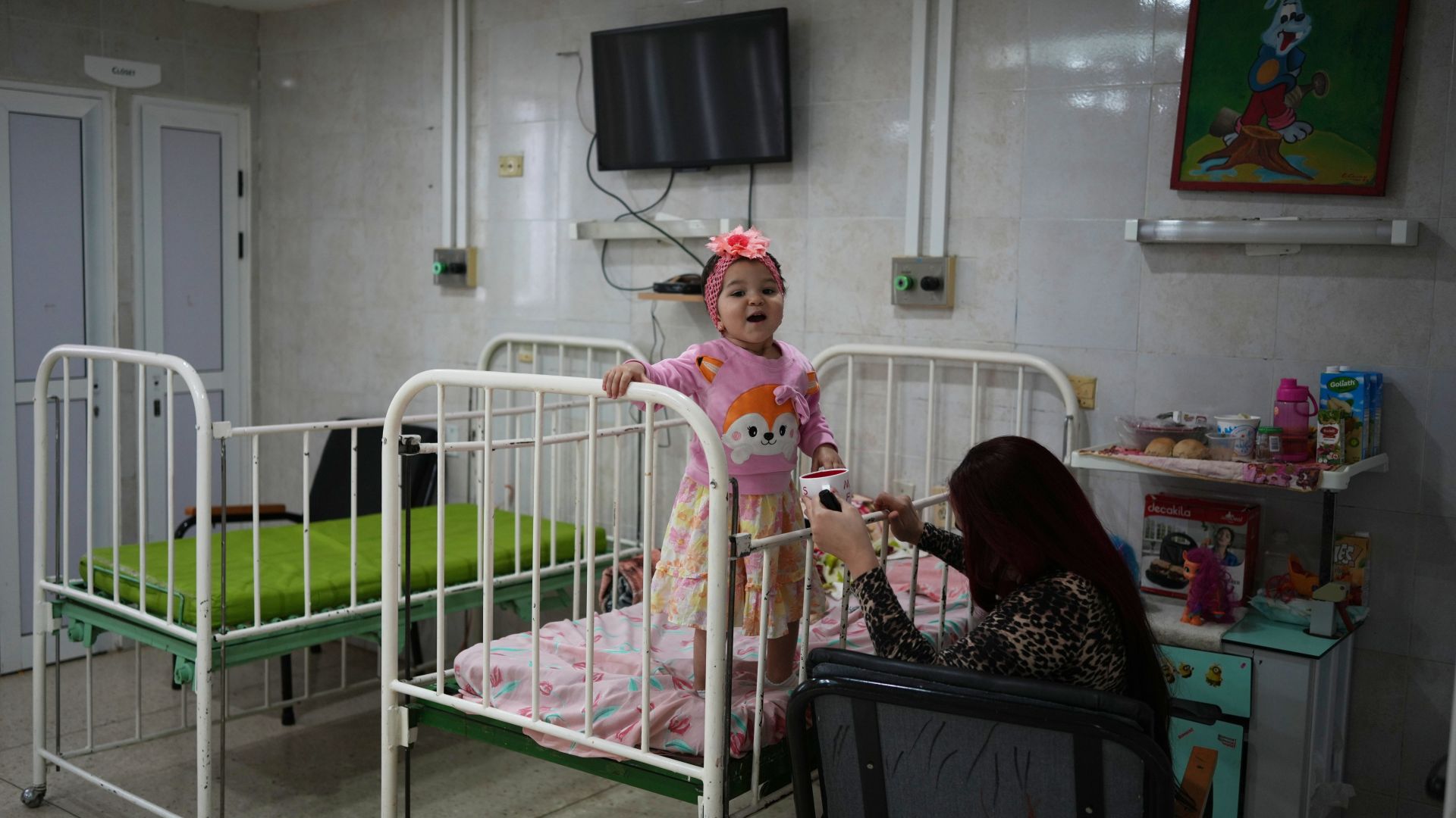 A patient stands on her bead at an oncology hospital in Havana, Cuba, Saturday, March 28, 2026, during a visit by members of the World Council of Churches. (AP Photo/Ramon Espinosa)