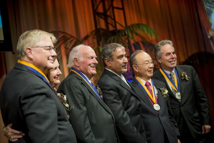 Group of people smiling with medals on