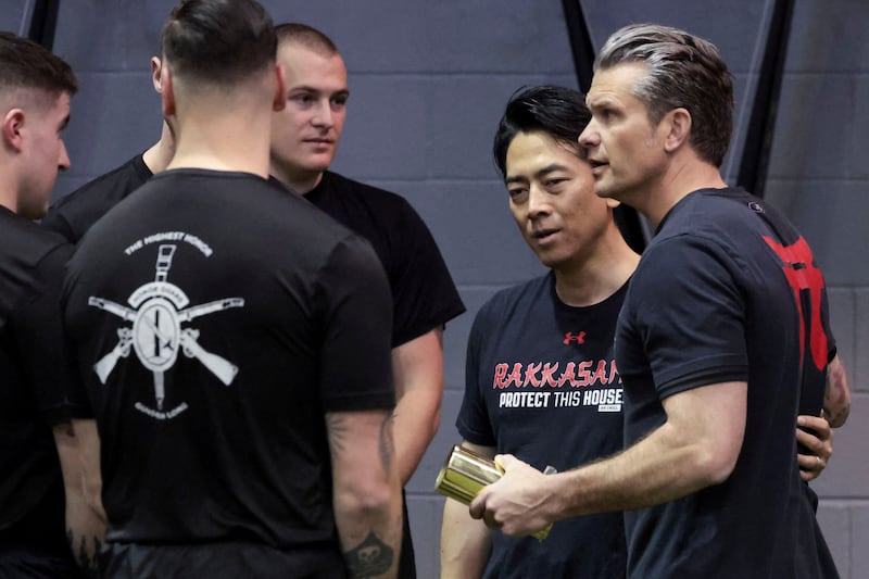 U.S. Secretary of Defense Pete Hegseth and Japanese Defense Minister Shinjiro Koizumi speak with soldiers from the U.S. Army's 3rd Infantry Regiment (The Old Guard) after engaging in a friendly workout competition in the gym at Joint Base Myer-Henderson Hall in Arlington, Virginia, U.S., January 15, 2026.