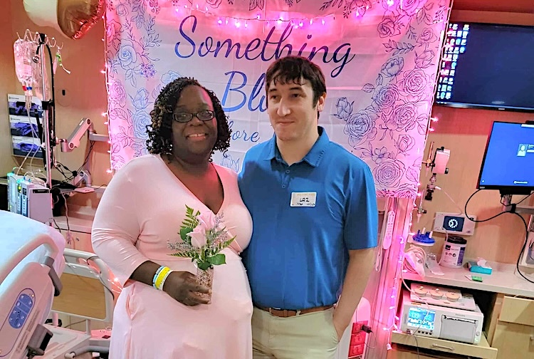 Couple smiles in patient room that filled with string lights and wedding decorations