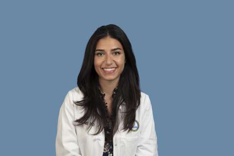 Portrait photo of Dr. Anasheh Halabi wearing a white doctor's coat.