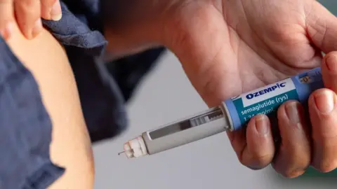 Getty Images A person injects weight-loss drug Ozempic