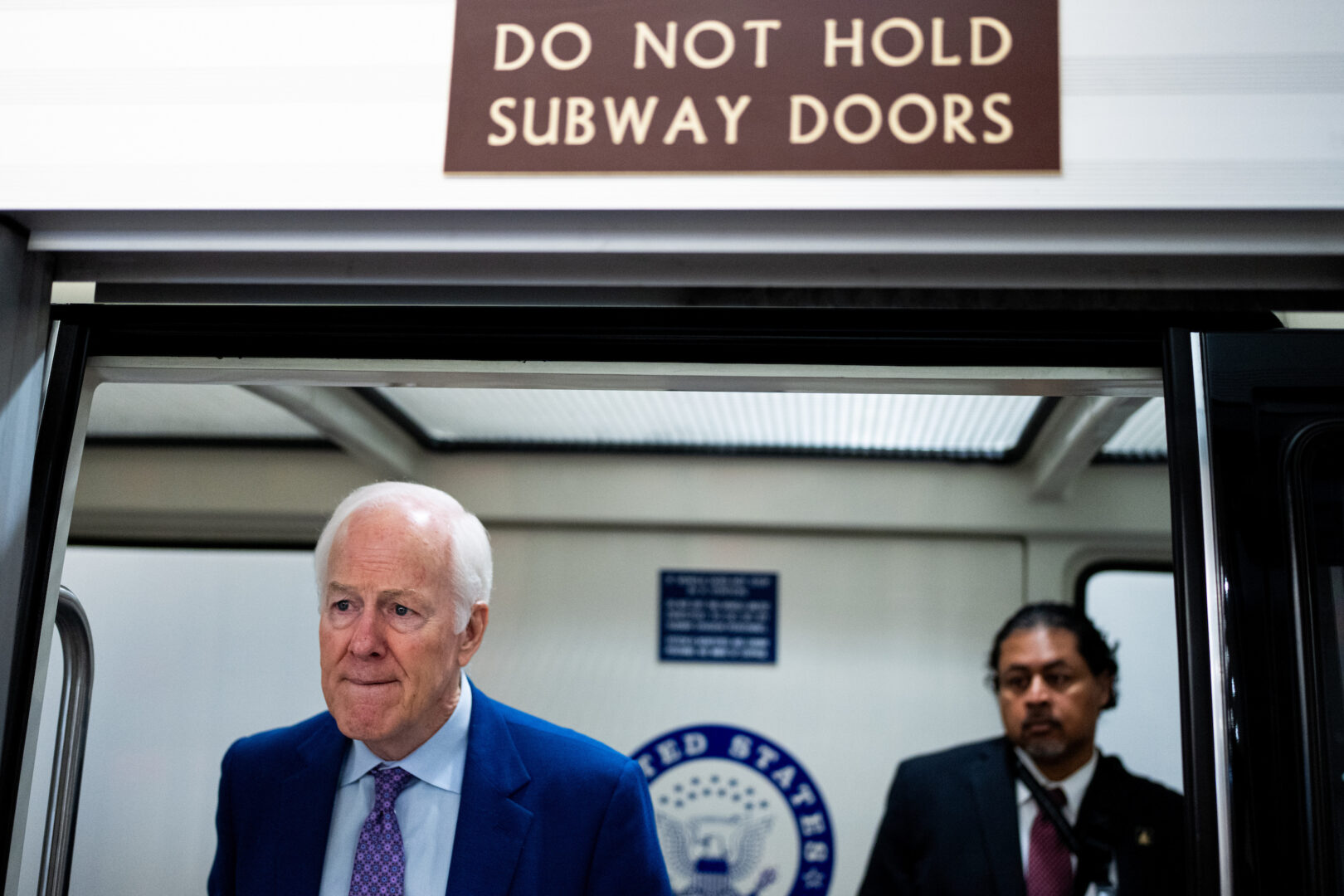 Sen. John Cornyn, R-Texas, speaks to a reporter as he boards the Senate subway in the Capitol on Thursday.