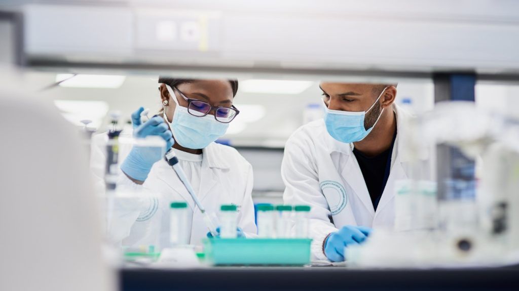 two young Black scientists conducting medical research in a laboratory