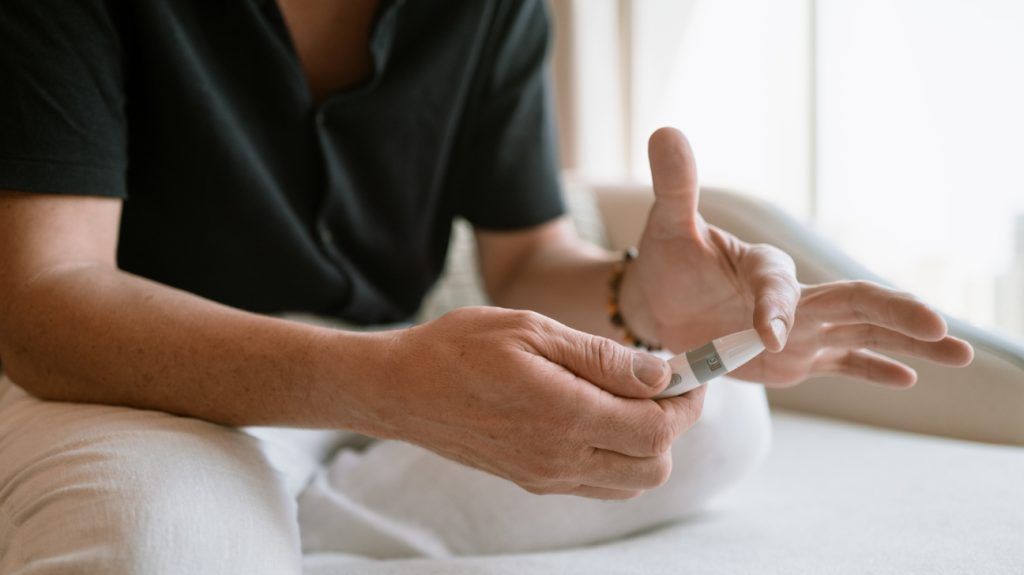 A person doing a finger-prick test.