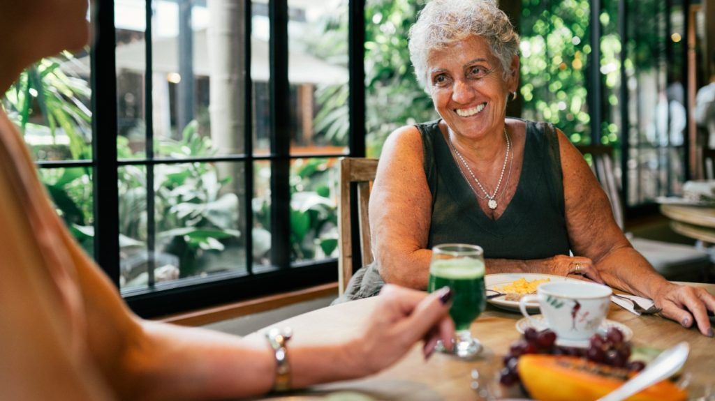 two older women sharing a meal