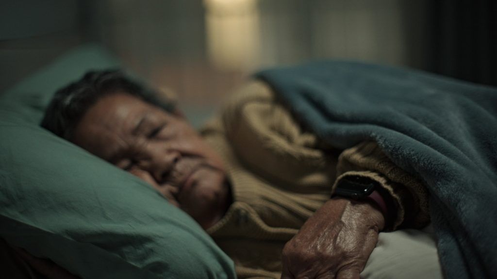 older Asian woman asleep in bed
