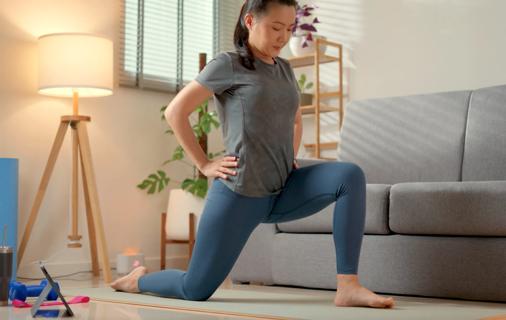 Woman doing a yoga stretch in their living room