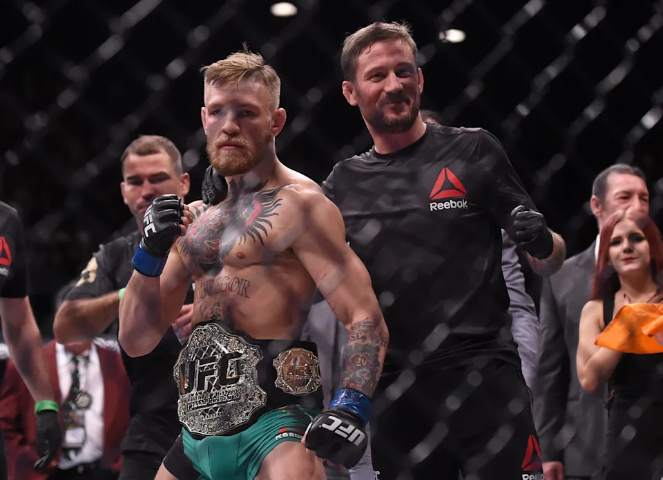 12 December 2015; UFC featherweight champion Conor McGregor with coach John Kavanagh following defeating Jose Aldo. UFC 194: Jose Aldo v Conor McGregor, MGM Grand Garden Arena, Las Vegas, USA. Picture credit: Ramsey Cardy / SPORTSFILE (Photo by Sportsfile/Corbis/Sportsfile via Getty Images)