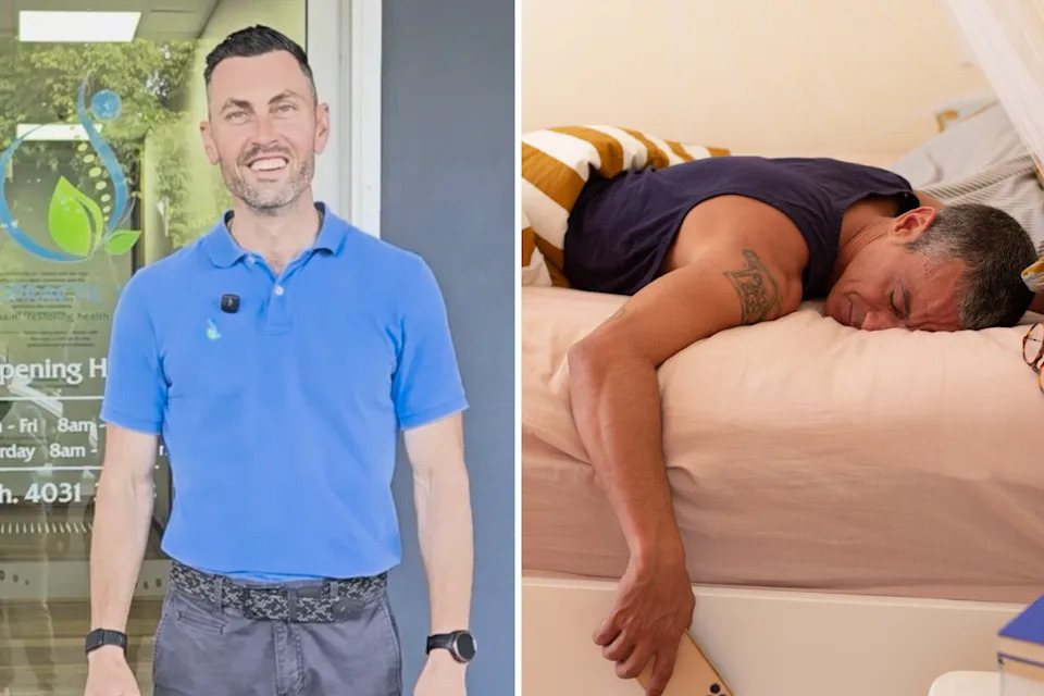 Man looking at the camera next to someone asleep