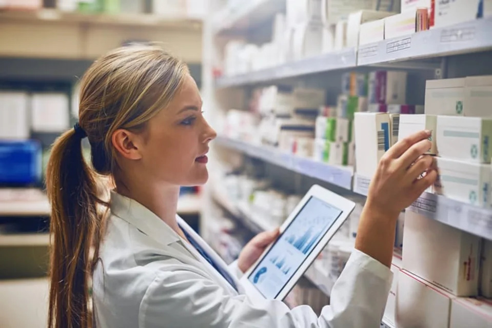 A medical professional is looking at medicine.