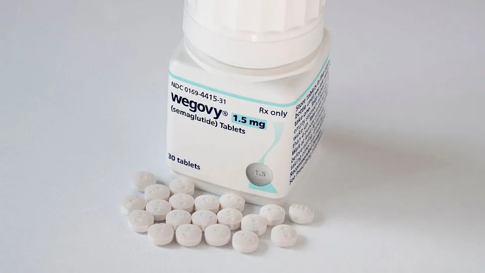 A pot of 1.5mg Wegovy medication with 30 tablets. The small white tablets can be seen resting next to the pot.