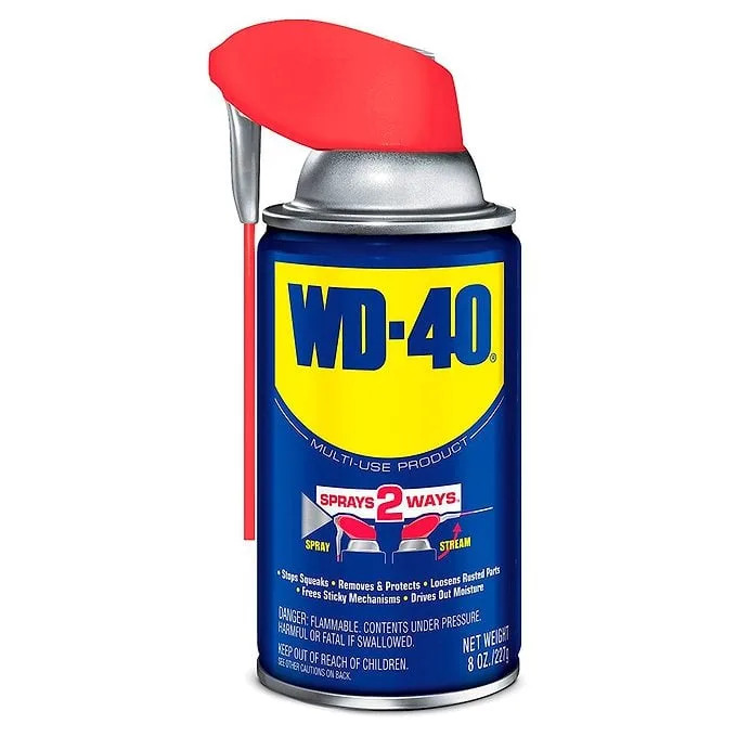 A blue aerosol can with a silver top and red spray nozzle dispenses lubricant, designed for maintenance tasks, labeled "WD-40, multi-use product."