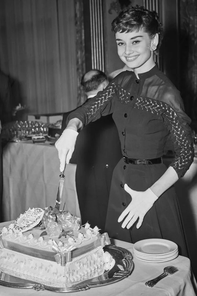 Audrey Hepburn cuts cake after filming 'Roman Holiday'Credit: Reg Burkett/Keystone/Hulton Archive/Getty