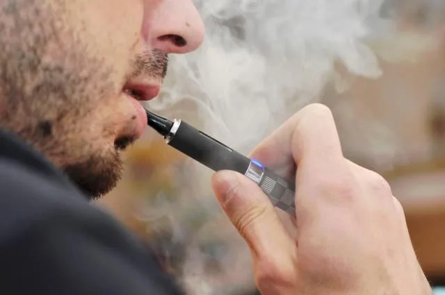 Stock photo of a person smoking a vape