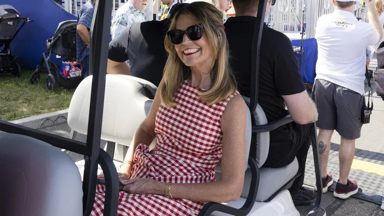 Savannah Guthrie wearing red gingham dress in golf cart