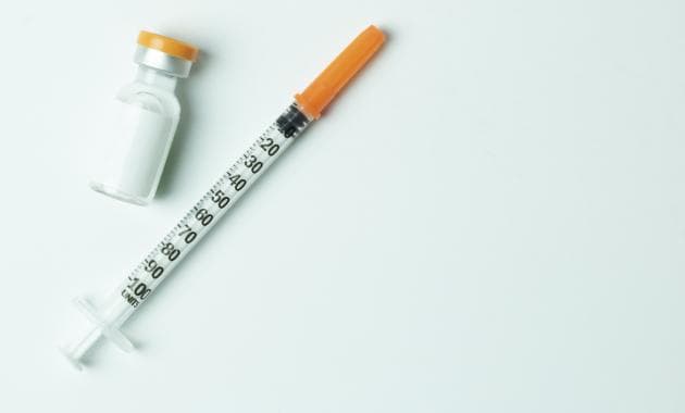 Injection and vial green background