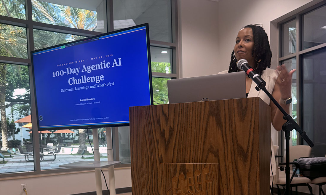 Arielle Theodore gestures while speaking at a podium during the Miller School’s Innovation Mixer and Agentic AI Summit, with a slide behind them titled “100-Day Agentic AI Challenge: Outcomes, Learnings, and What’s Next.”