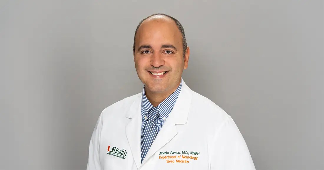 Dr. Albert Ramos, in white clinic coat