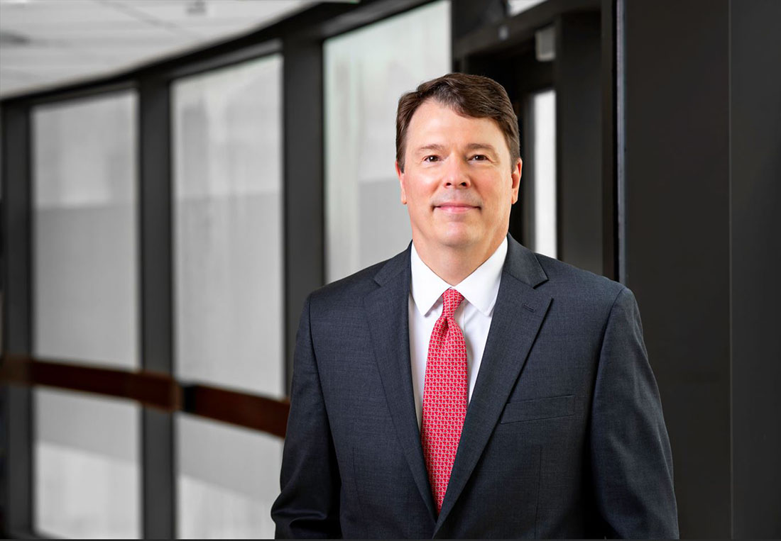 Dr. Stephen Gedde in dark suit and tie