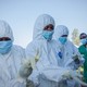 Volunteers put on equipment to assist with the Ebola epidemic in Bunia, the Democratic Republic of Congo