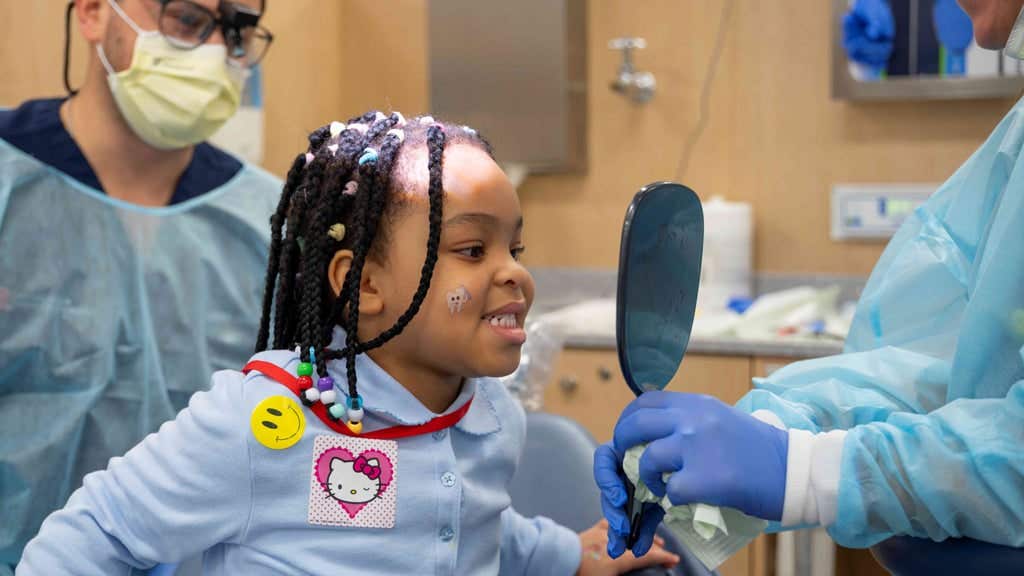 Dental students work on children’s teeth during Give Kids a Smile Day, a one-day event held in February at the school, serving New Jersey children.