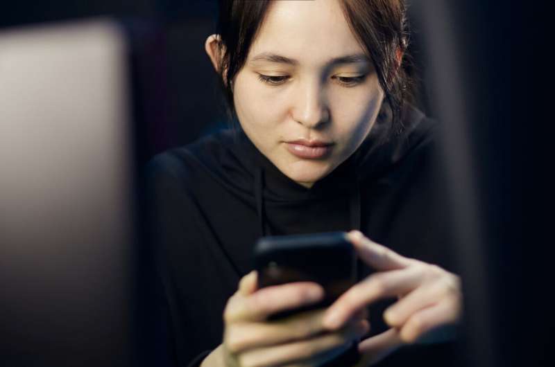 Woman scrolling phone.