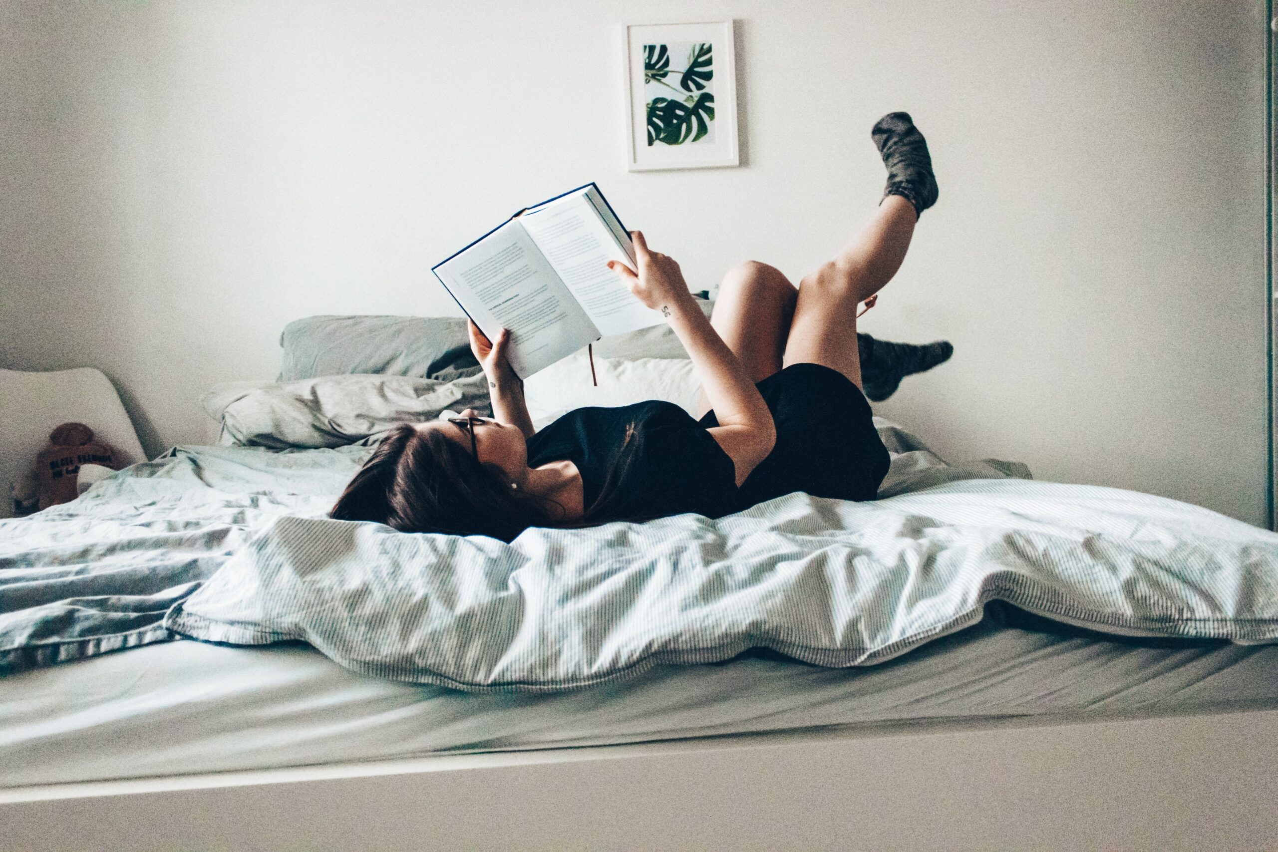 young woman reading in bed