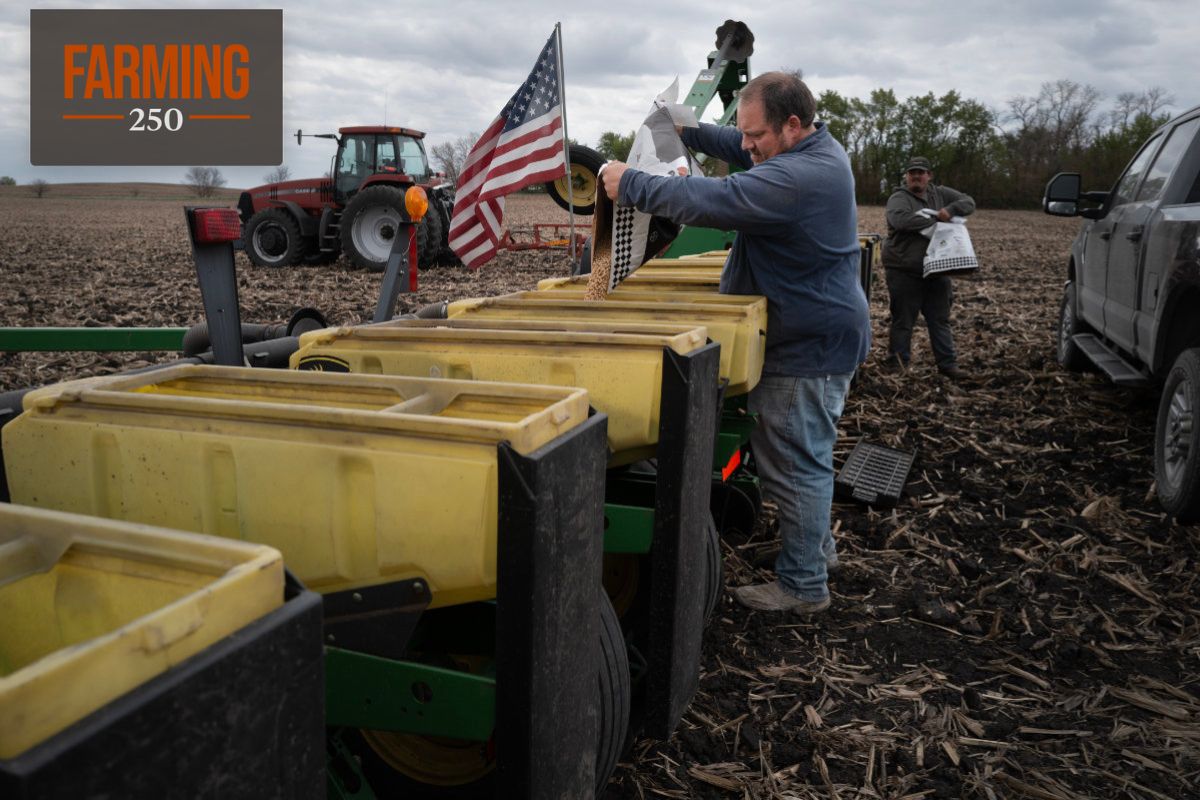 Alan Montag, a third-generation Iowa farmer, and his son Aden load soybean seed into a planter on May 6, 2026. (Photo credit: Scott Olson/Getty Images)