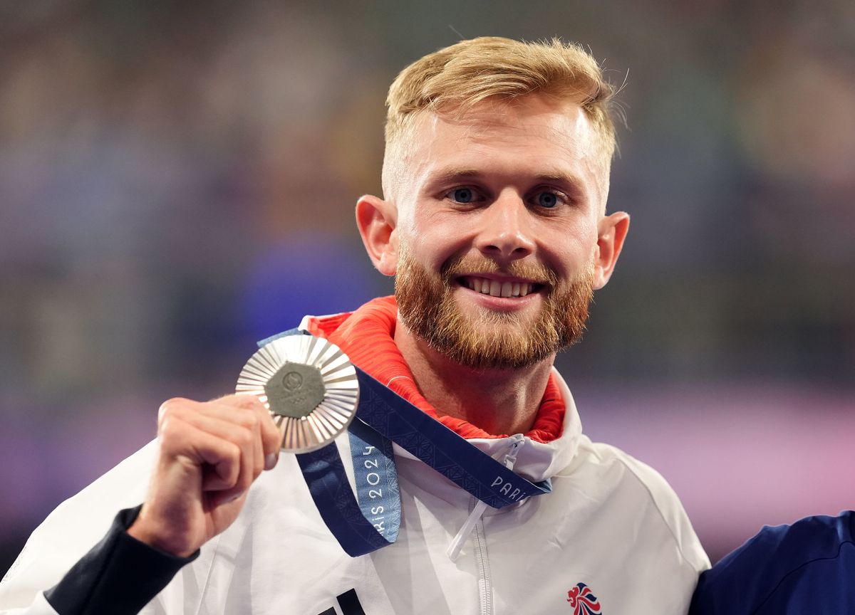 Josh Kerr shows off his silver medal in 2024