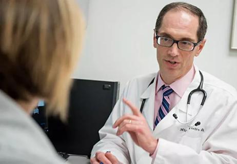 Dr. Regueiro speaking with patient