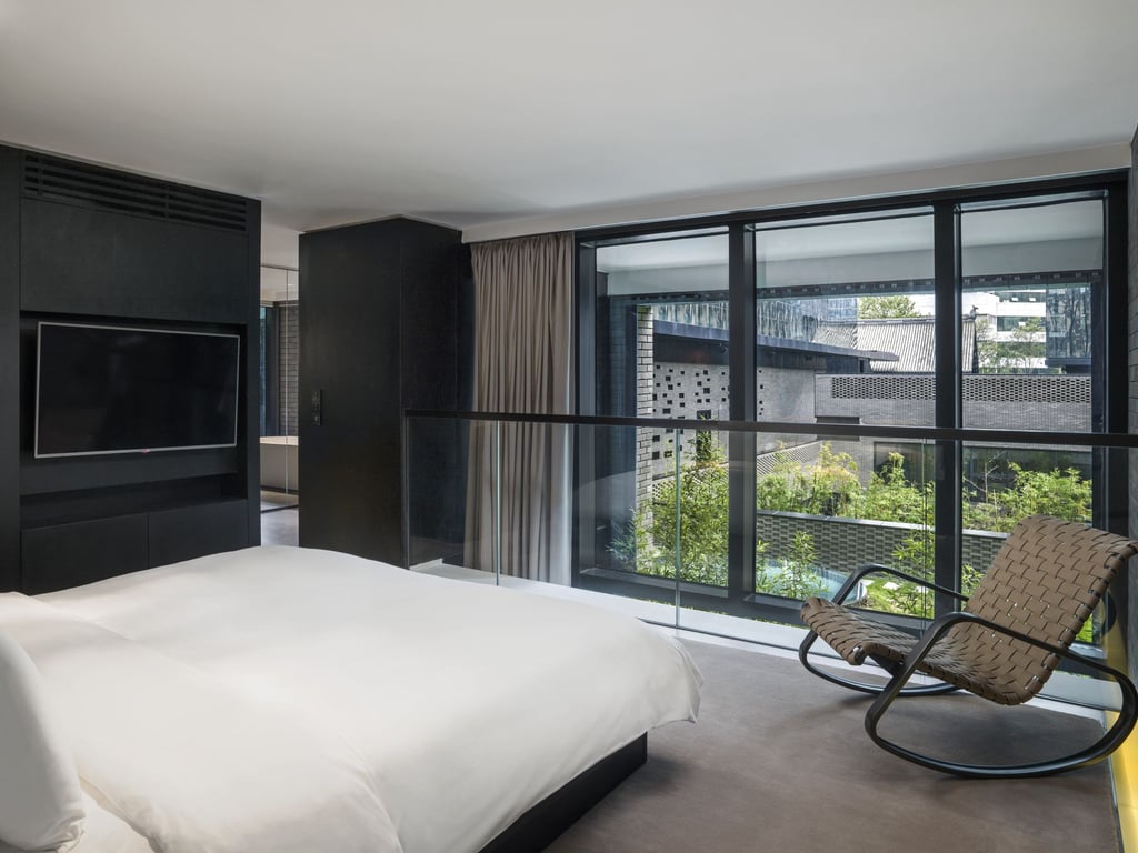 A bedroom in a Loft Suite overlooking one of the courtyards. Photo: Handout