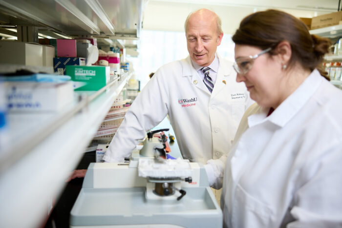 David Holtzman in his lab with another scientist